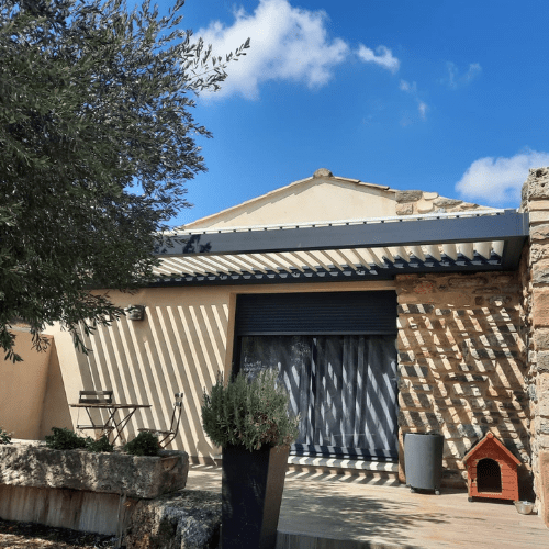 Pergola bioclimatique sur façade en pierre